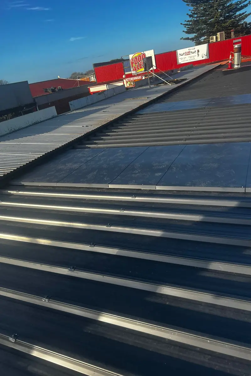 New dark long-run steel roof sheets installed by Delta Roofing