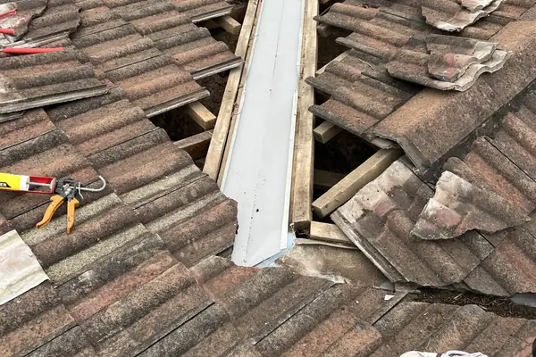 Concrete tile roof opened up along the valley to replace a worn valley tray and re-lay the tiles